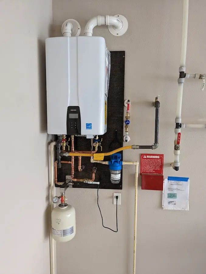 Professional plumber installing copper piping in a Tulia home